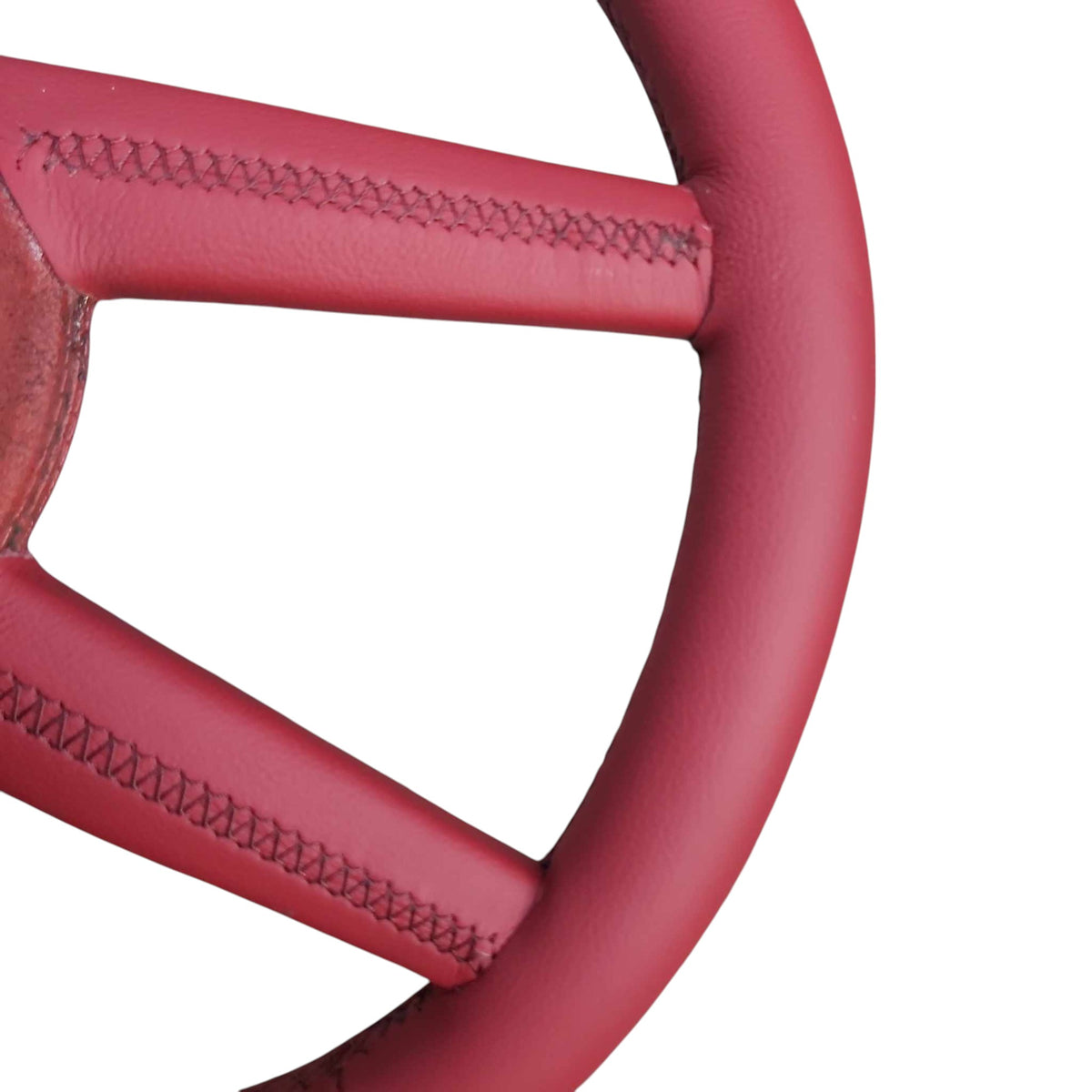 Close-up of stitching where the spoke meets the rim on a 4-spoke Sport steering wheel wrap