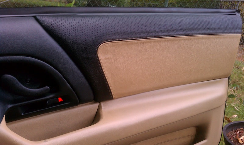 Tan leather upper door panel cover installed in a 4th-gen Camaro