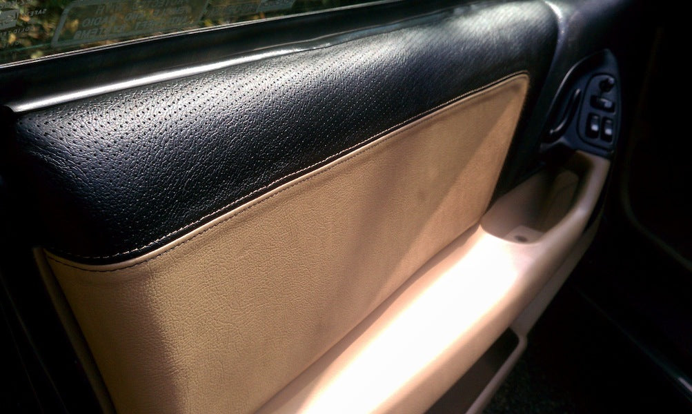 Tan leather upper door panel cover installed in a 4th-gen Camaro, view 3